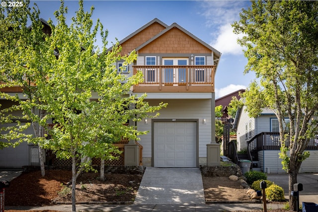 view of front of property with a balcony, a garage, and concrete driveway