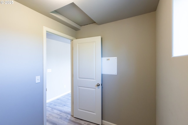 empty room featuring light wood-style flooring and baseboards