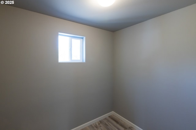 unfurnished room featuring baseboards and light wood-style floors