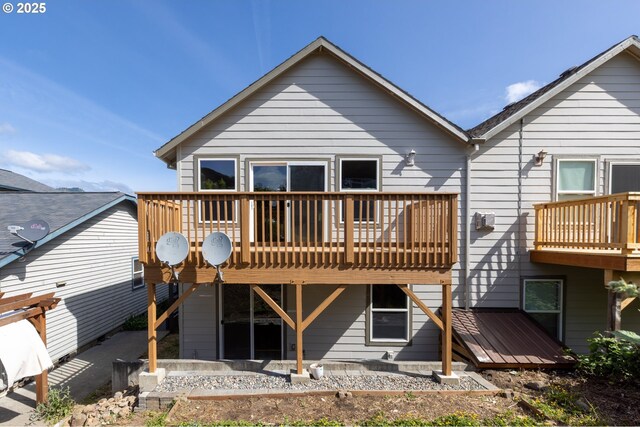 rear view of property featuring a deck