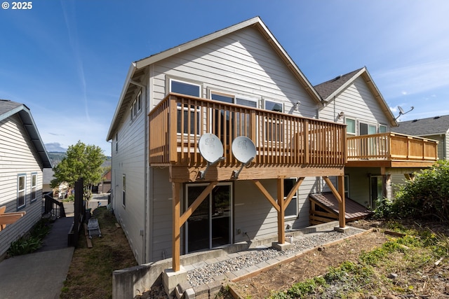 rear view of house with a wooden deck