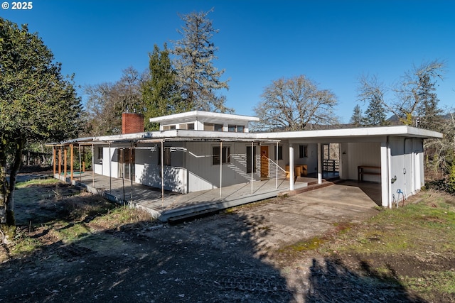 rear view of property featuring a carport