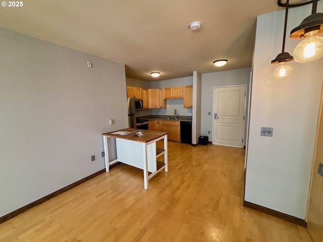 1134 SW Jefferson St Unit 503, Portland, OR 97201 - kitchen with stainless steel appliances, light wood finished floors, baseboards, light brown cabinets, and a sink