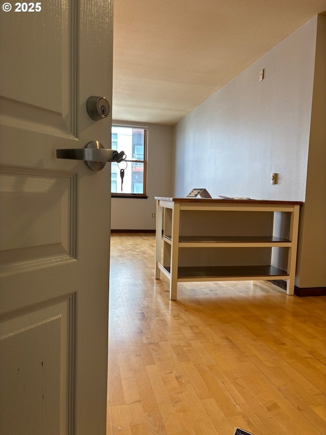 1134 SW Jefferson St Unit 503, Portland, OR 97201 - hallway featuring light wood-style floors and baseboards
