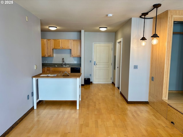 1134 SW Jefferson St Unit 503, Portland, OR 97201 - kitchen with a sink, dark countertops, light wood-style floors, and dishwasher