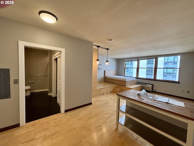 1134 SW Jefferson St Unit 503, Portland, OR 97201 - hall featuring wood finished floors, an AC wall unit, baseboards, and electric panel