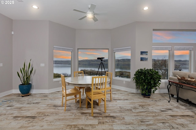 dining room featuring light wood-style flooring, baseboards, ceiling fan, and recessed lighting