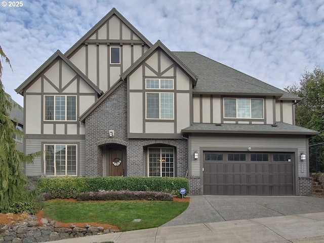 tudor house with a garage, brick siding, concrete driveway, roof with shingles, and stucco siding