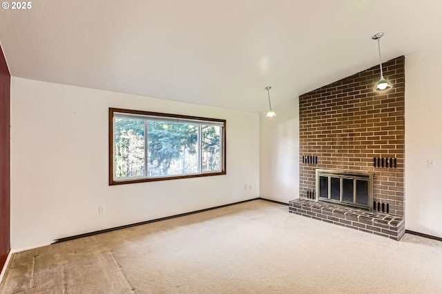 unfurnished living room with a brick fireplace, carpet flooring, vaulted ceiling, and baseboards