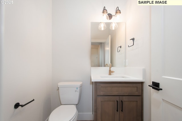 bathroom with toilet and vanity