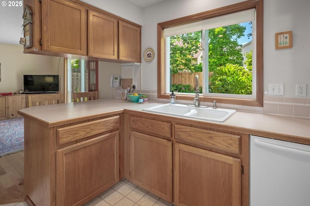 8911 SW 49th Ave, Portland, OR 97219 - kitchen featuring dishwasher, light countertops, a peninsula, and brown cabinetry