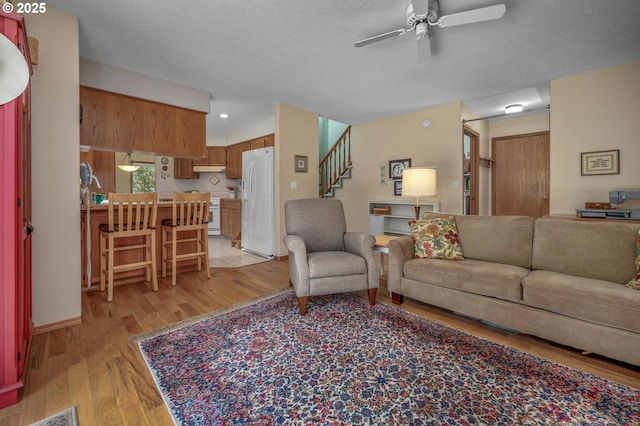 8911 SW 49th Ave, Portland, OR 97219 - living area with ceiling fan, light wood-style flooring, stairs, and recessed lighting
