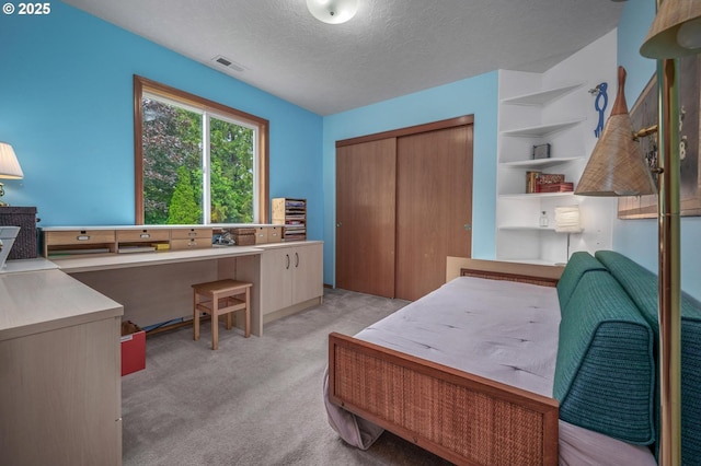 8911 SW 49th Ave, Portland, OR 97219 - bedroom with light carpet, a textured ceiling, a closet, and a desk