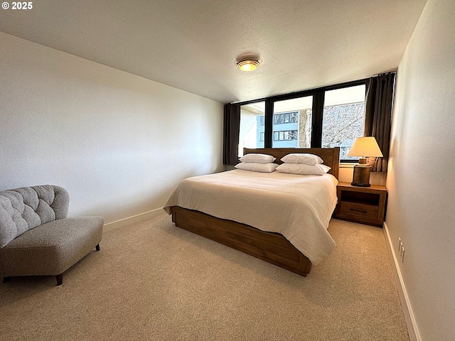 carpeted bedroom featuring baseboards