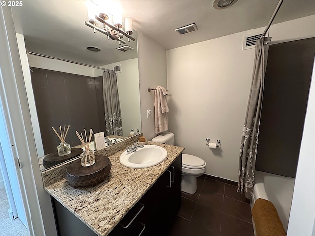 bathroom with tile patterned flooring, toilet, vanity, and visible vents