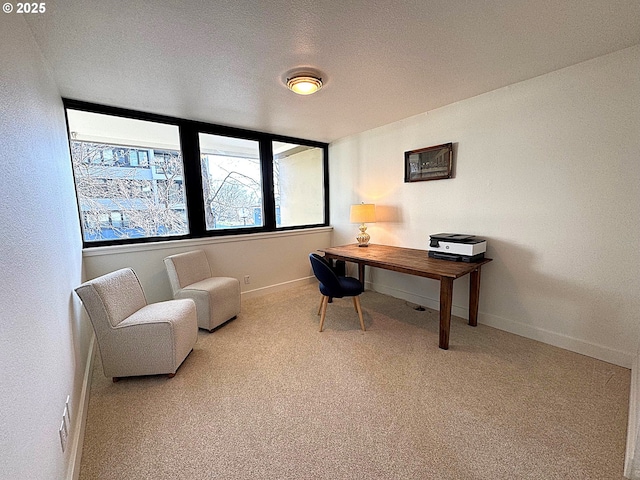 home office with baseboards and carpet floors