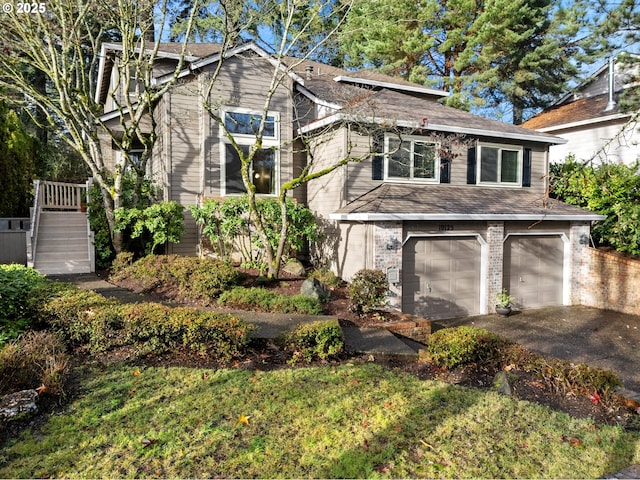 view of front of home with a front lawn and a garage