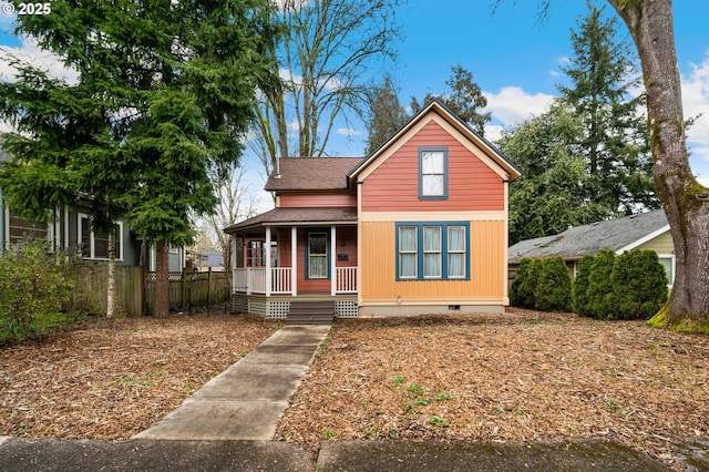 view of front of house with a shingled roof, covered porch, and crawl space