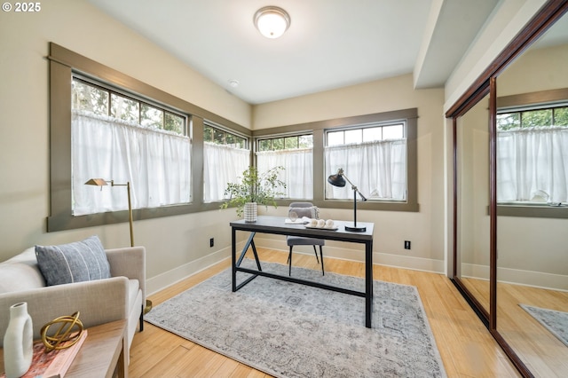 office space featuring baseboards and wood finished floors