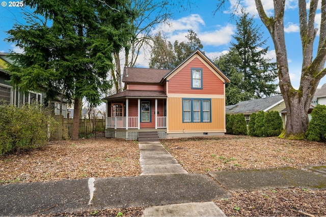 view of front of home with crawl space, covered porch, and roof with shingles