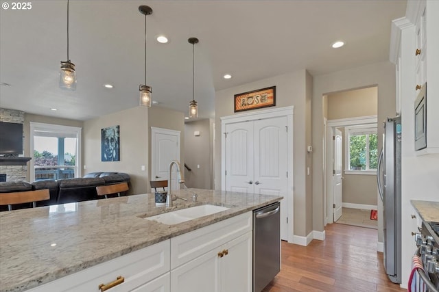 2871 Wing Tip Ave, Salem, OR 97304 - kitchen featuring stainless steel appliances, open floor plan, white cabinets, light wood-style floors, and recessed lighting