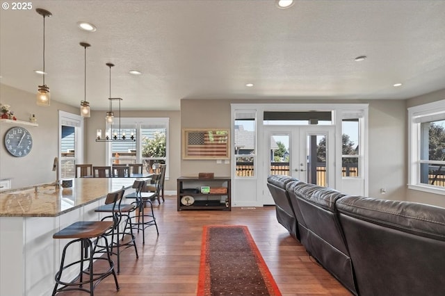 2871 Wing Tip Ave, Salem, OR 97304 - living area featuring dark wood-style flooring, healthy amount of natural light, a textured ceiling, recessed lighting, and french doors