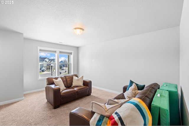 living area with visible vents, light carpet, a textured ceiling, and baseboards