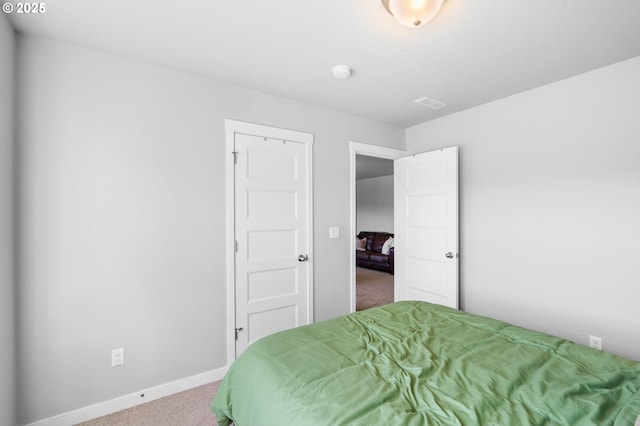 bedroom with carpet flooring and baseboards