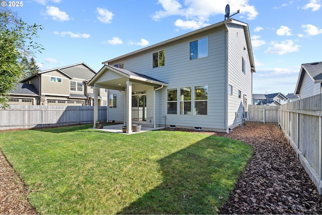 back of property featuring crawl space, a patio area, a fenced backyard, and a yard