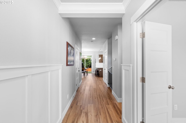 hallway featuring light wood-style floors and baseboards