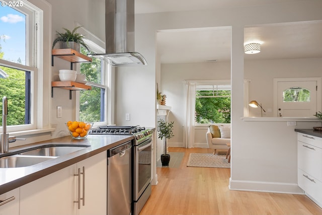 kitchen featuring island range hood, appliances with stainless steel finishes, white cabinetry, and open shelves