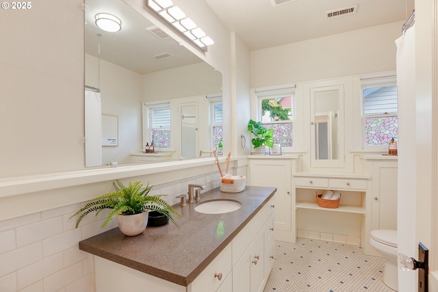 bathroom featuring toilet and vanity