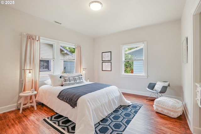 bedroom featuring wood finished floors and baseboards