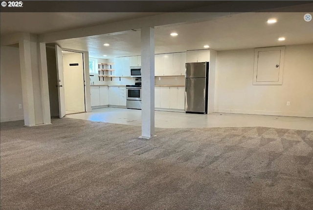 finished basement with freestanding refrigerator, light colored carpet, recessed lighting, and baseboards