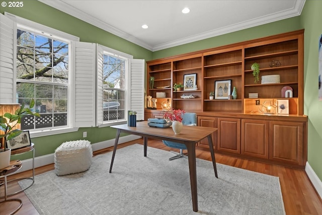 home office with ornamental molding and light wood-type flooring