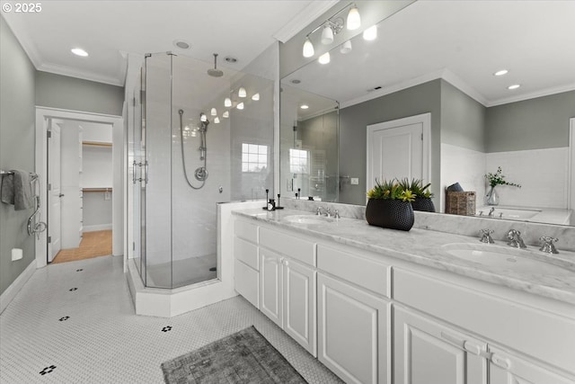 bathroom featuring vanity, tile patterned flooring, crown molding, and a shower with door