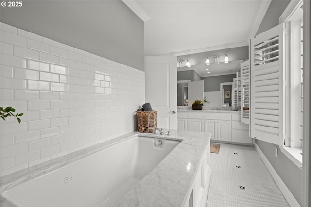 bathroom featuring tile patterned flooring, vanity, a bath, and crown molding