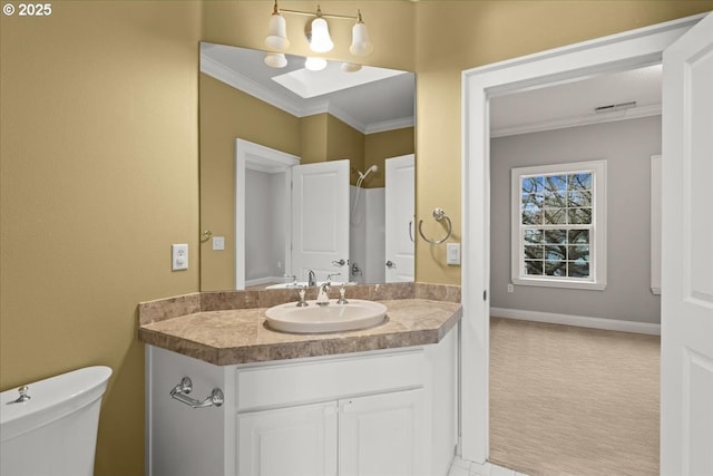 bathroom with crown molding, vanity, and toilet