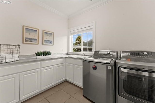 washroom with sink, light tile patterned floors, cabinets, independent washer and dryer, and ornamental molding