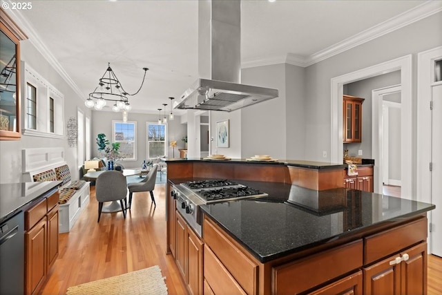 kitchen featuring stainless steel appliances, island exhaust hood, a kitchen island, and decorative light fixtures