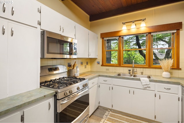 2112 Agate St, Eugene, OR 97403 - kitchen with stainless steel appliances, wood ceiling, backsplash, and light countertops