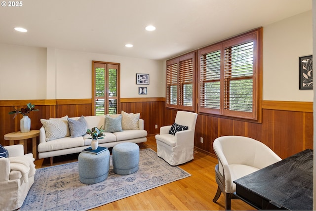 2112 Agate St, Eugene, OR 97403 - living room featuring a wainscoted wall, wooden walls, light wood-style floors, and recessed lighting