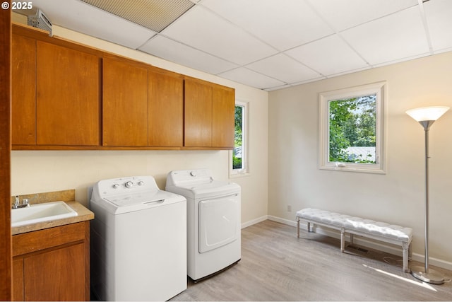 2112 Agate St, Eugene, OR 97403 - laundry area featuring cabinet space, washer and dryer, plenty of natural light, and light wood-style flooring