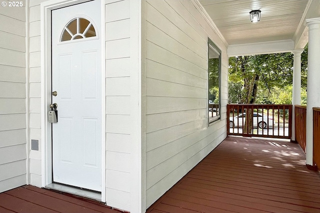 view of exterior entry featuring covered porch