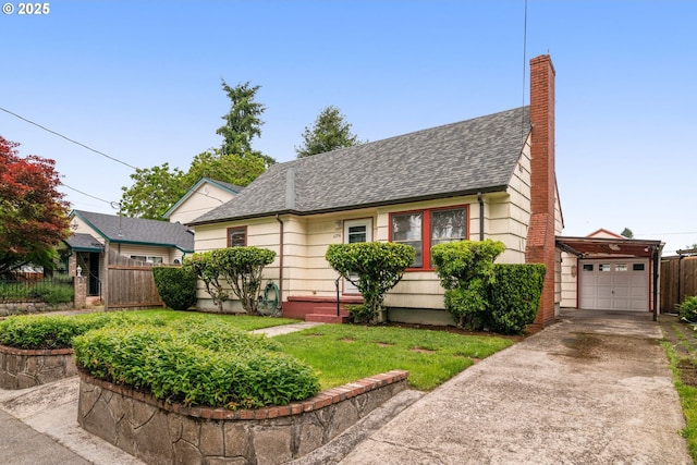 6356 N Omaha Ave, Portland, OR 97217 - view of front facade with roof with shingles, concrete driveway, a chimney, and a garage