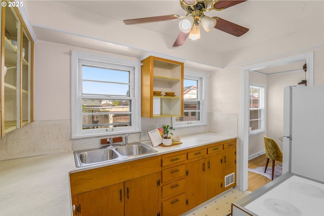 6356 N Omaha Ave, Portland, OR 97217 - kitchen with freestanding refrigerator, a sink, light countertops, and healthy amount of natural light