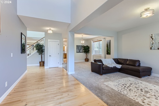 living room featuring a chandelier and light wood-type flooring