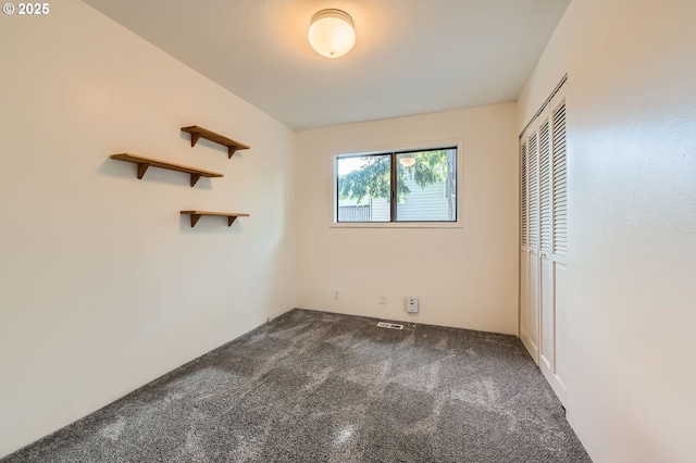 12140 SE Henderson Dr, Portland, OR 97266 - unfurnished bedroom featuring dark carpet and a closet