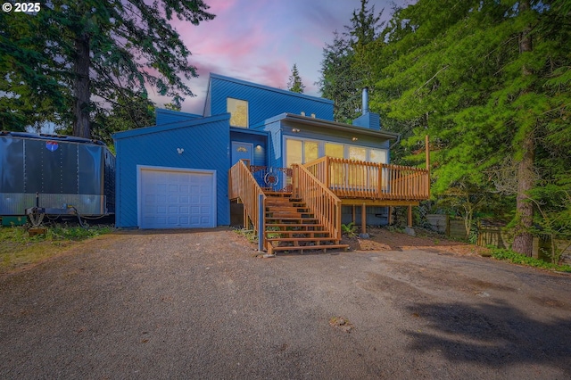 12140 SE Henderson Dr, Portland, OR 97266 - view of front of house with stairs, driveway, a deck, a garage, and a chimney
