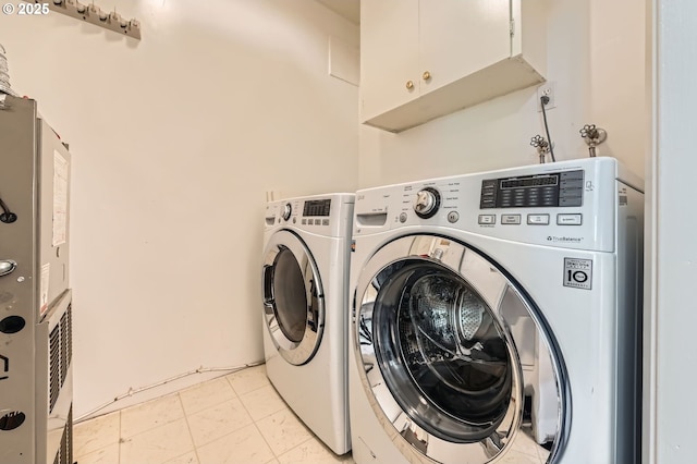 12140 SE Henderson Dr, Portland, OR 97266 - laundry room featuring cabinet space and separate washer and dryer